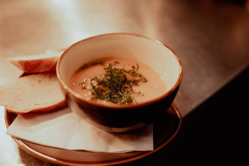soup in bowl and bread on plate