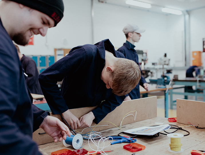 electrical students working on equipment