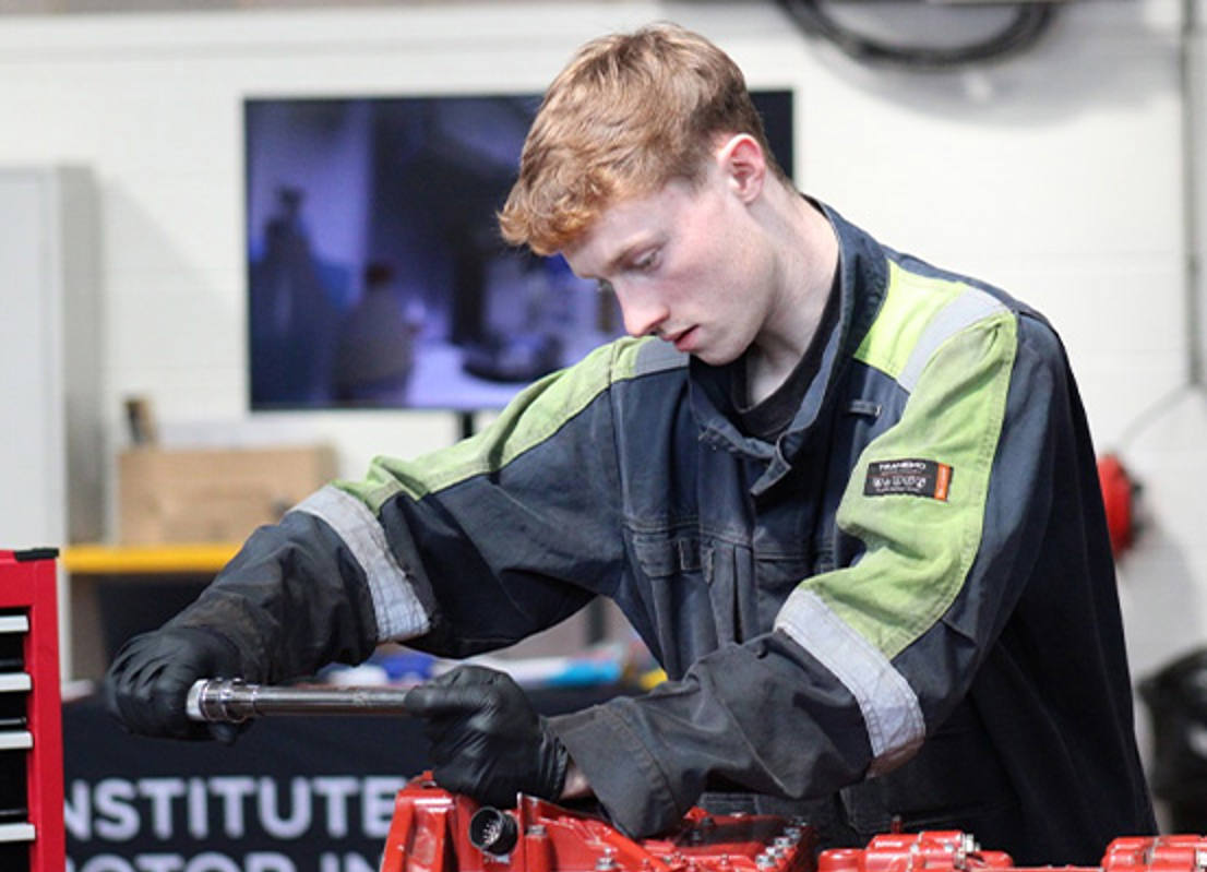 male mechanic student using equipment