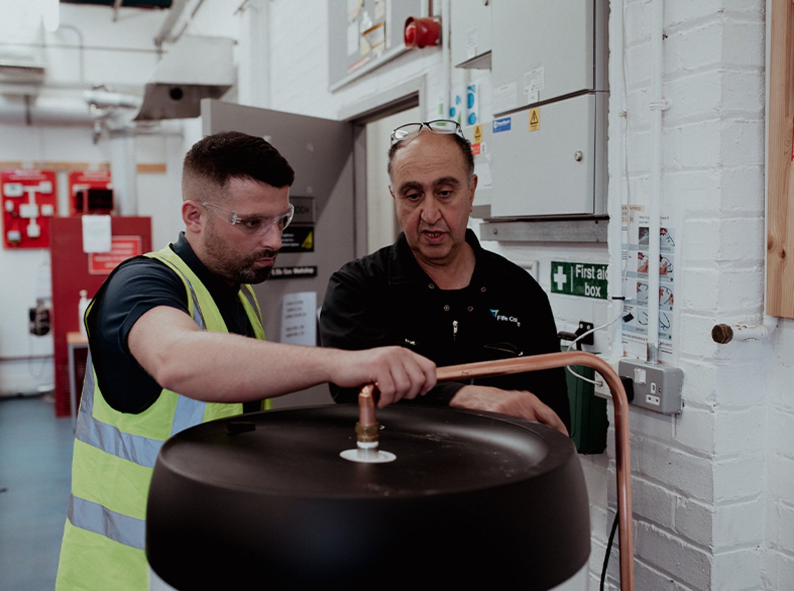 gas male student and lecturer working on apparatus