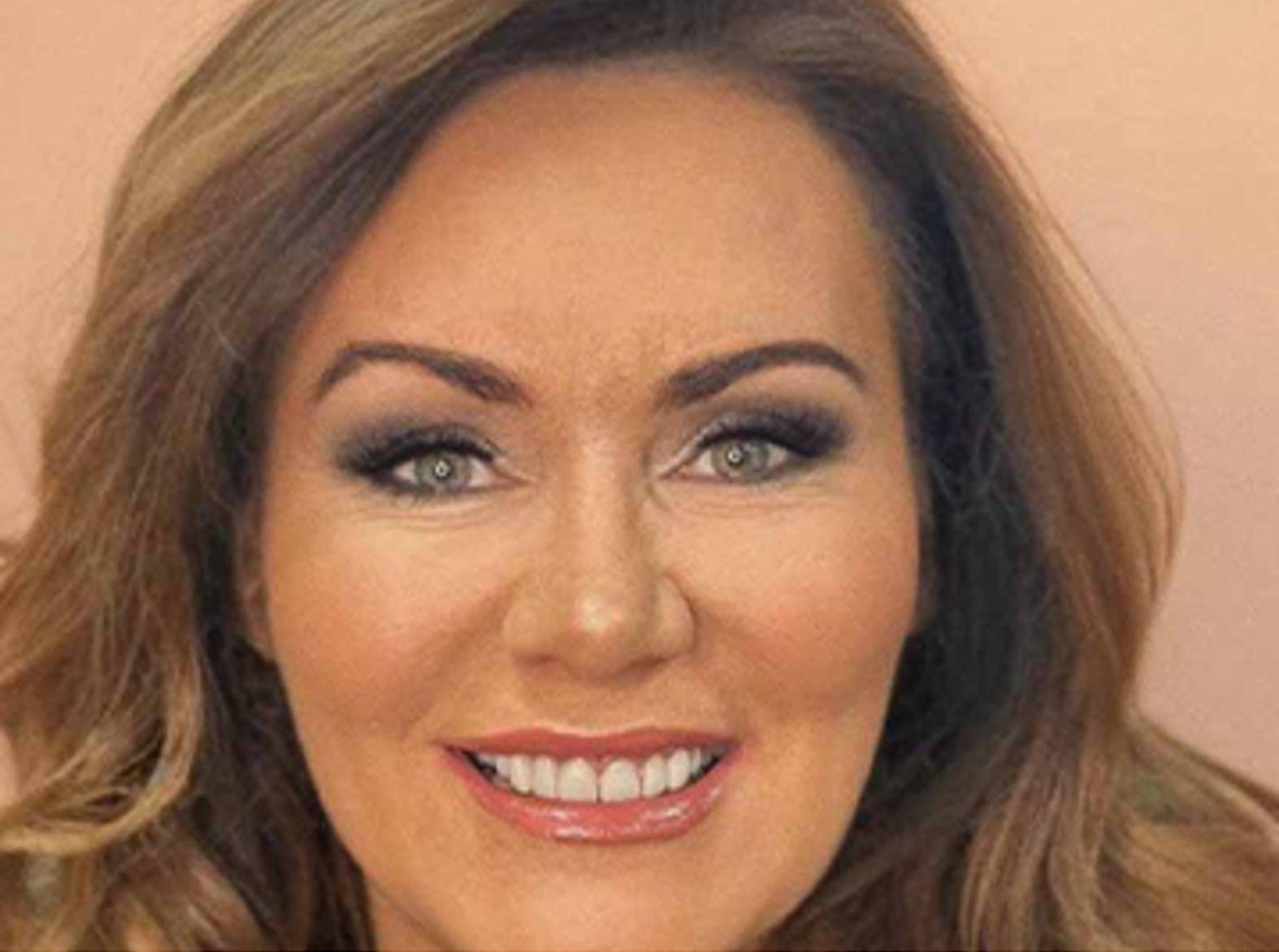 tracey aitken alumni smiling at camera