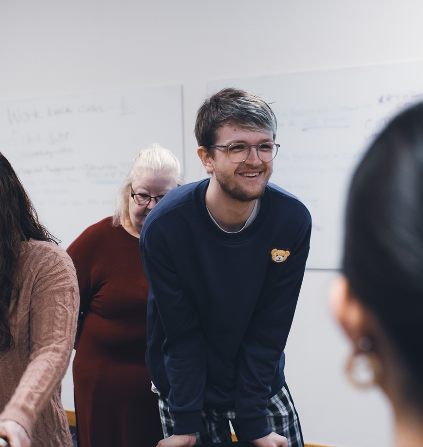 childcare male student smiling in class