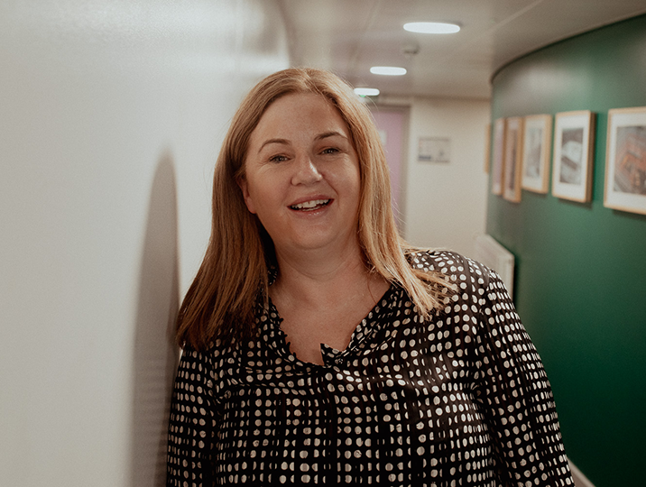 female student smiling at camera in corridor