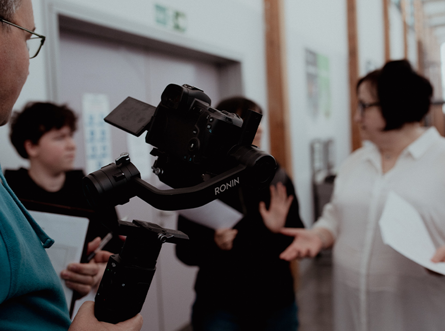 broadcast media student using equipment in corridor
