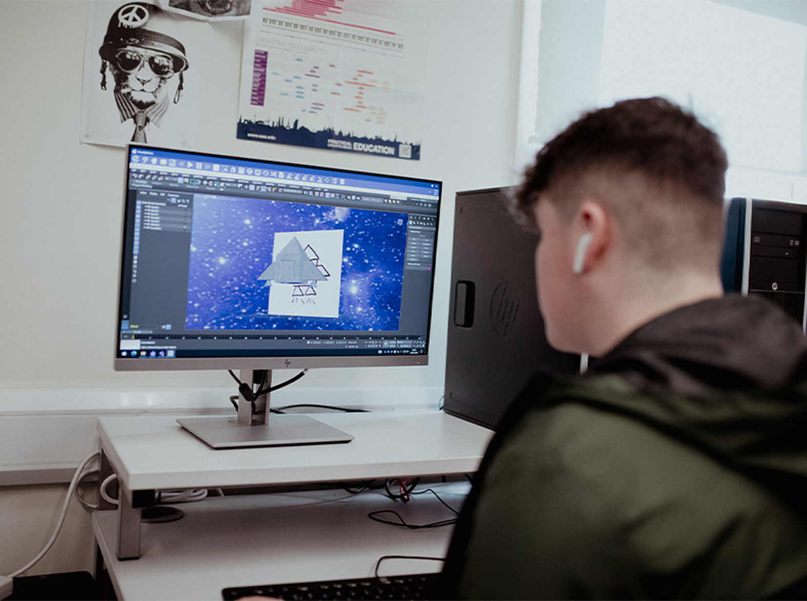 male student looking at work on computer