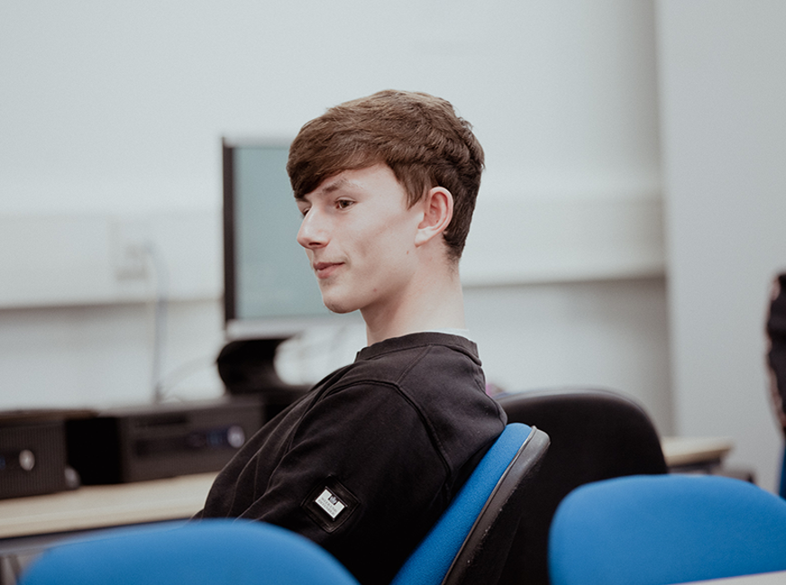 male student focusing in class sitting down