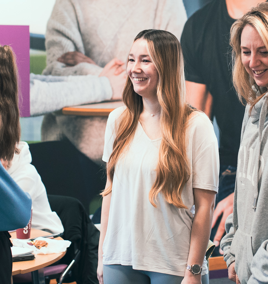 group of students smiling in class