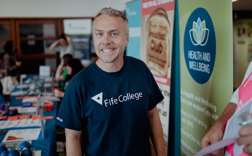 health and wellbeing staff member john smiling at camera