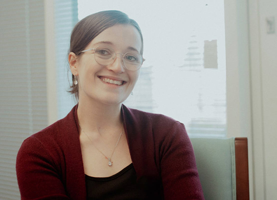 female student with glasses smiling 