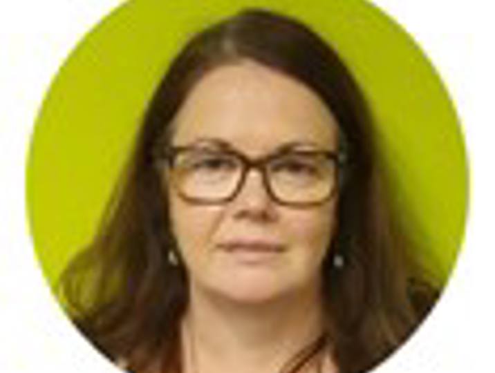 staff member lynne with green background