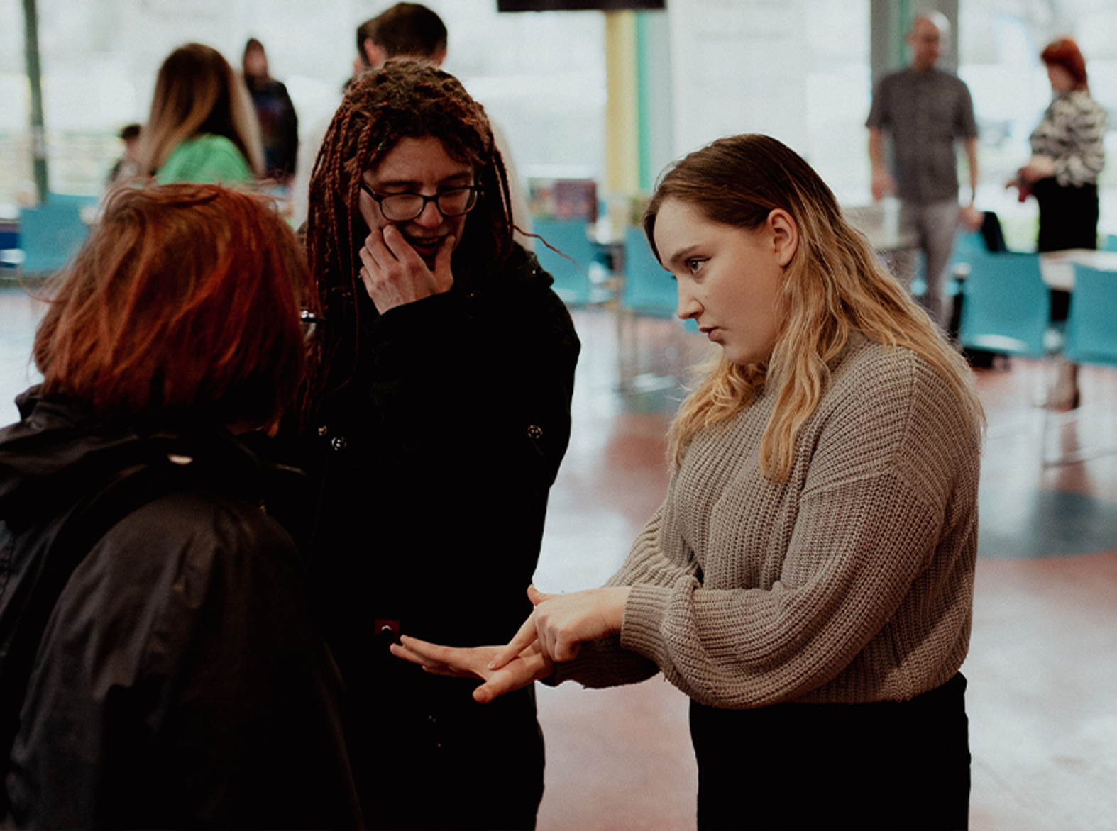 three students talking to each other in glenrothes refectory